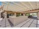 An outdoor kitchen with shaded pergola, brick flooring, cooking area, and outdoor dining space, great for entertaining at 4455 W Ford Ave, Las Vegas, NV 89139