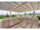 Outdoor kitchen area features a built-in grill, stainless steel appliances, and a counter at 4455 W Ford Ave, Las Vegas, NV 89139