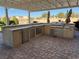 Outdoor kitchen equipped with stainless steel appliances, including a grill, sink, and refrigerator at 4455 W Ford Ave, Las Vegas, NV 89139