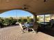 Inviting covered patio with ample seating overlooking the beautifully landscaped backyard at 4455 W Ford Ave, Las Vegas, NV 89139