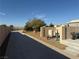 Yard featuring well equipment and long driveway against a bright blue sky at 4455 W Ford Ave, Las Vegas, NV 89139
