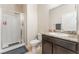 Clean bathroom with a shower, single sink, and granite countertops at 4524 Stardusk Falls Ave, North Las Vegas, NV 89084