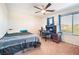 Bright bedroom featuring two windows, ceiling fan, and neutral carpet for a welcoming feel at 4524 Stardusk Falls Ave, North Las Vegas, NV 89084