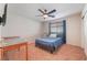 Relaxing bedroom with ceiling fan, table and TV for maximum comfort at 4524 Stardusk Falls Ave, North Las Vegas, NV 89084