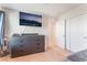 This bedroom offers a mounted TV, dresser, and closet at 4524 Stardusk Falls Ave, North Las Vegas, NV 89084