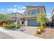 Charming two-story home featuring a manicured yard, two-car garage, and inviting curb appeal at 4524 Stardusk Falls Ave, North Las Vegas, NV 89084