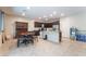Open kitchen/dining area with dark wood cabinets, granite countertops, and stainless steel appliances at 4524 Stardusk Falls Ave, North Las Vegas, NV 89084