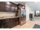 Spacious kitchen with stainless steel appliances, dark wood cabinets, and an eat-in dining area at 4524 Stardusk Falls Ave, North Las Vegas, NV 89084
