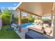Inviting pool with a covered patio area, lounge seating, and well-manicured landscaping at 4524 Stardusk Falls Ave, North Las Vegas, NV 89084