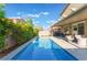 Refreshing pool features a water feature, seating, and lush green foliage at 4524 Stardusk Falls Ave, North Las Vegas, NV 89084