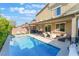 Sparkling pool surrounded by patio space, lounge area, and mature landscaping at 4524 Stardusk Falls Ave, North Las Vegas, NV 89084