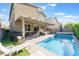 Backyard oasis showcasing a sparkling private pool, covered patio, and outdoor seating area at 4524 Stardusk Falls Ave, North Las Vegas, NV 89084