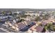 Scenic aerial view showcases a lively community with palm trees, townhomes, and city views at 5000 Red Rock St # 237, Las Vegas, NV 89118