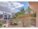 Balcony view of blue skies, lush trees, and neighborhood homes with red tile roofs at 5000 Red Rock St # 237, Las Vegas, NV 89118