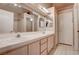 A well-lit bathroom features a double sink vanity, large mirror and walk-in shower at 5000 Red Rock St # 237, Las Vegas, NV 89118
