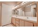 A well-lit bathroom features a double sink vanity, large mirror and walk-in shower at 5000 Red Rock St # 237, Las Vegas, NV 89118