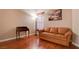 A simple bedroom with a light brown sofa, wooden floors, and a large picture frame at 5000 Red Rock St # 237, Las Vegas, NV 89118