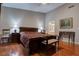 A spacious bedroom with red and orange curtains, hard wood floors and ceiling fan at 5000 Red Rock St # 237, Las Vegas, NV 89118