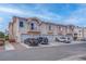 Exterior of a row of stucco townhomes with garages and a well-maintained landscape at 5000 Red Rock St # 237, Las Vegas, NV 89118
