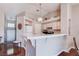 An open kitchen features sleek countertops, a breakfast bar, wood cabinets, and hardwood floors at 5000 Red Rock St # 237, Las Vegas, NV 89118
