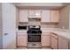 The kitchen features stainless steel appliances, white cabinets, and plenty of counter space at 5000 Red Rock St # 237, Las Vegas, NV 89118