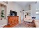 Bright living room featuring a media center, sliding closet doors, and wood floors at 5000 Red Rock St # 237, Las Vegas, NV 89118