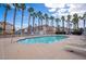A shared swimming pool surrounded by palm trees and lounge chairs provides a relaxing atmosphere at 5000 Red Rock St # 237, Las Vegas, NV 89118