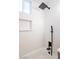 Bright bathroom showcasing a new tub and shower with sleek, black fixtures and modern, white tiling at 54 E Texas Ave, Henderson, NV 89015
