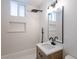 Modern bathroom features a sleek, black rainfall shower head and updated vanity with white countertop at 54 E Texas Ave, Henderson, NV 89015