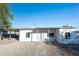 Charming single-story home with a clean white facade and a well-maintained gravel front yard at 54 E Texas Ave, Henderson, NV 89015