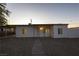 Charming single-story home featuring a minimalist design, white exterior, and low-maintenance gravel landscaping at 54 E Texas Ave, Henderson, NV 89015