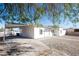 Newly renovated single-story home boasting a spacious driveway, well-kept gravel landscaping, and covered carport at 54 E Texas Ave, Henderson, NV 89015