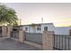 Charming home featuring secure fencing, well-maintained gravel front yard, and inviting curb appeal at 54 E Texas Ave, Henderson, NV 89015