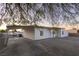 Single-story home featuring a spacious driveway, well-kept gravel landscaping, and covered carport at 54 E Texas Ave, Henderson, NV 89015