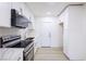 Modern kitchen showcasing sleek white cabinets, stainless steel appliances, and a contrasting gold faucet at 54 E Texas Ave, Henderson, NV 89015