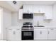 Modern kitchen features white cabinets, stainless steel appliances, and white countertops at 54 E Texas Ave, Henderson, NV 89015
