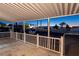 Inviting covered patio features white railings and views into the neighborhood, creating a perfect outdoor retreat at 54 E Texas Ave, Henderson, NV 89015