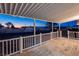 Wide-angle view of a covered patio with white railings showcasing evening skyline views and an inviting outdoor space at 54 E Texas Ave, Henderson, NV 89015