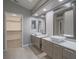 Primary bathroom features dual sinks, modern vanity, and access to large closet at 5452 Big Sky Ln, Las Vegas, NV 89149