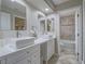 Modern bathroom with dual sinks, white cabinets, and bathtub/shower combo at 5452 Big Sky Ln, Las Vegas, NV 89149