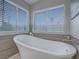 Elegant soaking tub with natural light and serene views through blinds, promoting relaxation at 5452 Big Sky Ln, Las Vegas, NV 89149