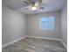 Neutral bedroom with wood-look floors and a window at 5452 Big Sky Ln, Las Vegas, NV 89149