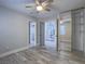 Spacious bedroom featuring wood-look flooring, a ceiling fan, and access to the main living space at 5452 Big Sky Ln, Las Vegas, NV 89149