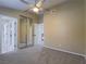 Inviting bedroom with carpet, ceiling fan, and mirrored closet doors at 5452 Big Sky Ln, Las Vegas, NV 89149