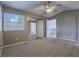 Neutral bedroom with carpet, ceiling fan, and mirrored closet doors at 5452 Big Sky Ln, Las Vegas, NV 89149