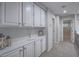 Upstairs hallway with built-in cabinets providing ample storage and neutral carpeting at 5452 Big Sky Ln, Las Vegas, NV 89149