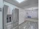 Modern kitchen boasting stainless steel refrigerator and bright breakfast nook with window seat at 5452 Big Sky Ln, Las Vegas, NV 89149