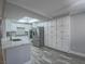 Spacious white kitchen with stainless steel appliances, tile backsplash, and center island at 5452 Big Sky Ln, Las Vegas, NV 89149