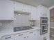 Close-up of kitchen featuring gas range, stainless steel appliances, and herringbone backsplash at 5452 Big Sky Ln, Las Vegas, NV 89149