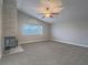 Inviting living room featuring high ceilings, a ceiling fan, and a stone fireplace at 5452 Big Sky Ln, Las Vegas, NV 89149
